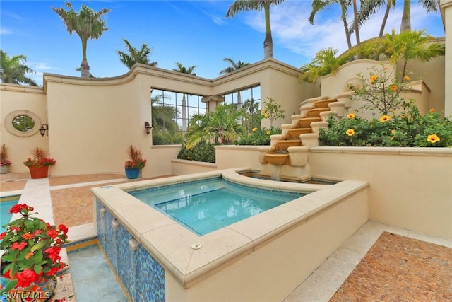 view of pool with an in ground hot tub