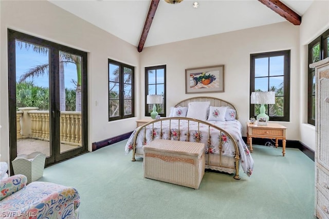 carpeted bedroom featuring multiple windows, vaulted ceiling with beams, and access to exterior