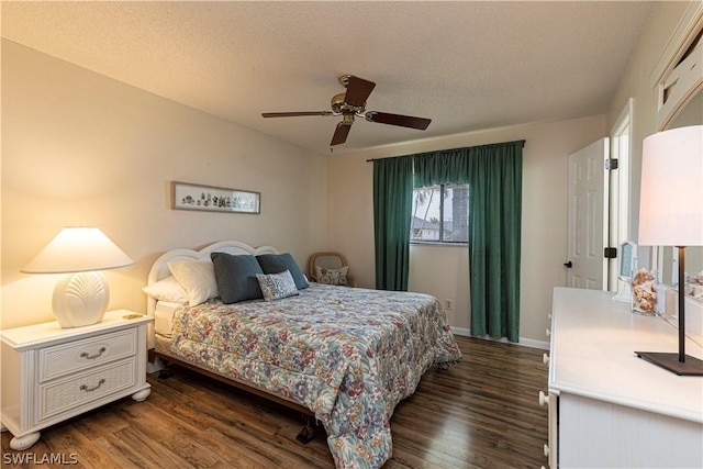 bedroom with ceiling fan, dark hardwood / wood-style floors, and a textured ceiling