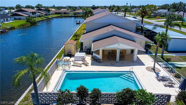 view of swimming pool featuring a water view, an outdoor bar, and a patio