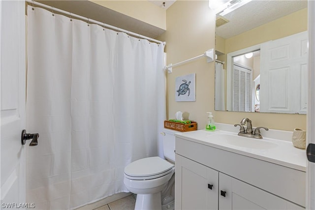 bathroom with tile patterned flooring, a shower with curtain, vanity, and toilet