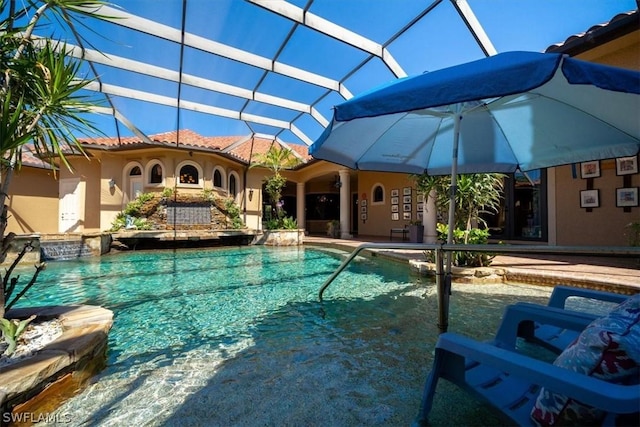 view of swimming pool featuring a lanai and a patio