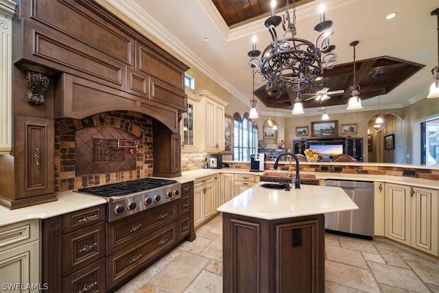 kitchen with sink, cream cabinets, ornamental molding, backsplash, and appliances with stainless steel finishes