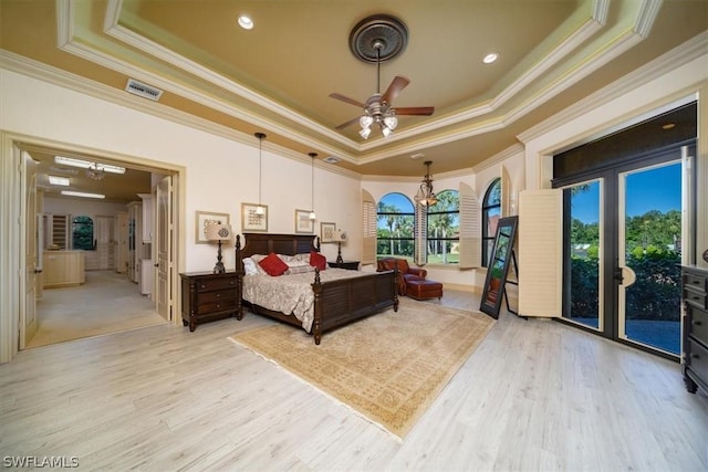 bedroom featuring a raised ceiling, light hardwood / wood-style floors, ceiling fan, ornamental molding, and access to exterior