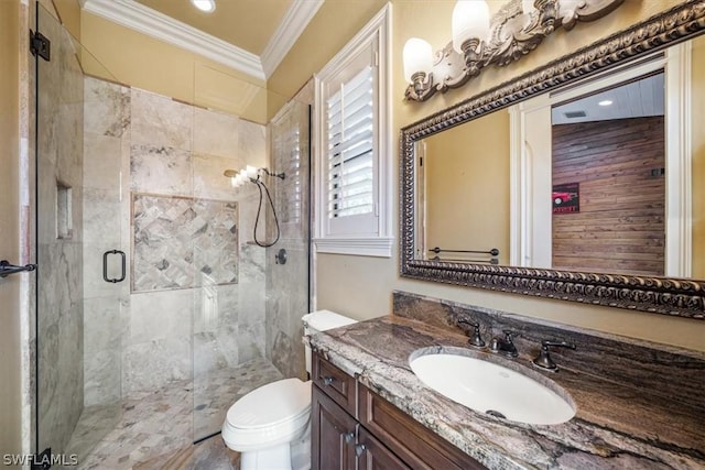 bathroom featuring toilet, a shower with door, vanity, and crown molding