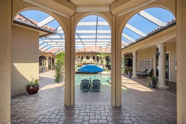 view of patio / terrace featuring glass enclosure