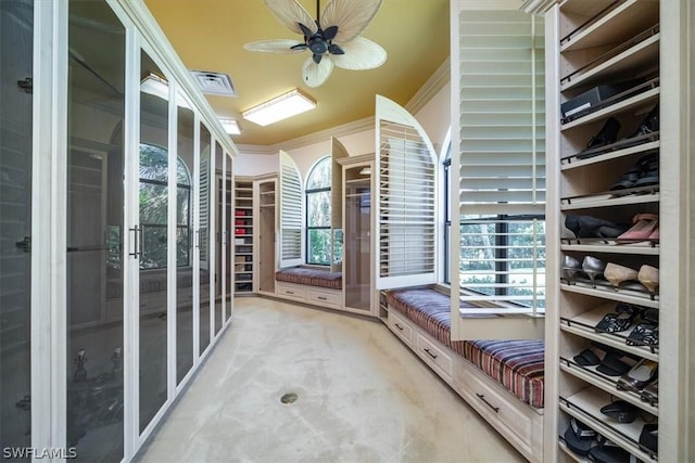 interior space with ceiling fan and light colored carpet