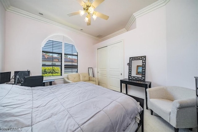 bedroom with ceiling fan, a closet, and crown molding