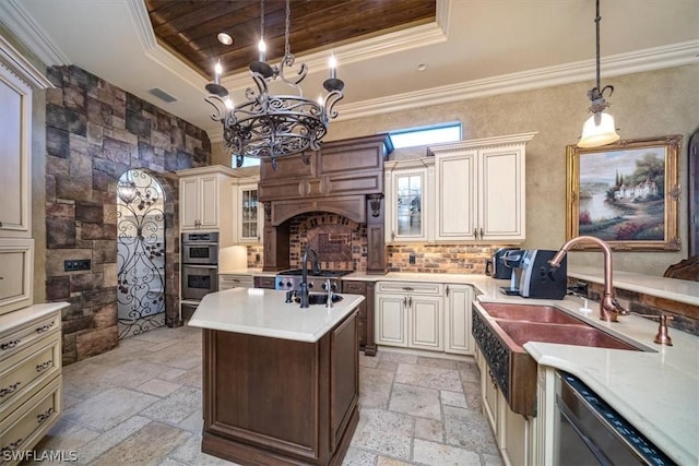 kitchen featuring decorative light fixtures, dishwasher, cream cabinets, a raised ceiling, and stainless steel double oven