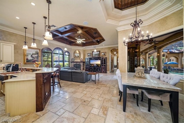 dining room featuring ceiling fan with notable chandelier, ornamental molding, and coffered ceiling