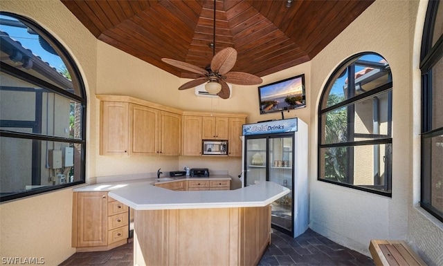 kitchen with ceiling fan, wood ceiling, light brown cabinetry, and stainless steel appliances