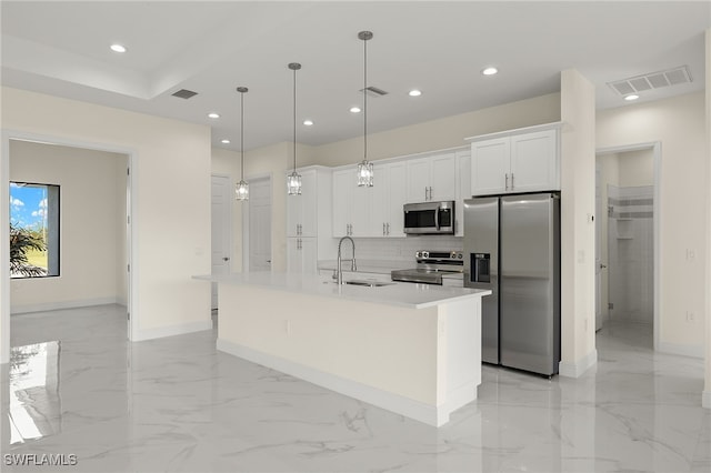 kitchen with stainless steel appliances, a sink, baseboards, white cabinetry, and recessed lighting