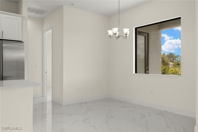 unfurnished dining area featuring light marble finish flooring, a chandelier, and baseboards