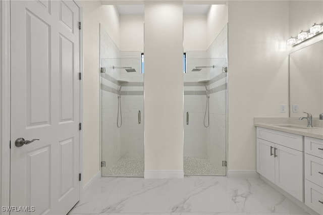 full bath featuring baseboards, a stall shower, vanity, and marble look tile flooring