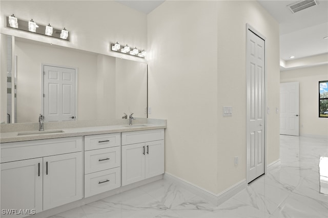 full bath with marble look tiles, baseboards, double vanity, and recessed lighting