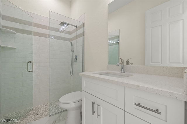 bathroom featuring toilet, a shower stall, vanity, and marble finish flooring