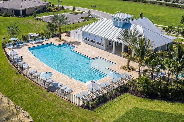 view of pool with a yard and a patio area