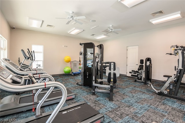 exercise room with dark colored carpet and ceiling fan