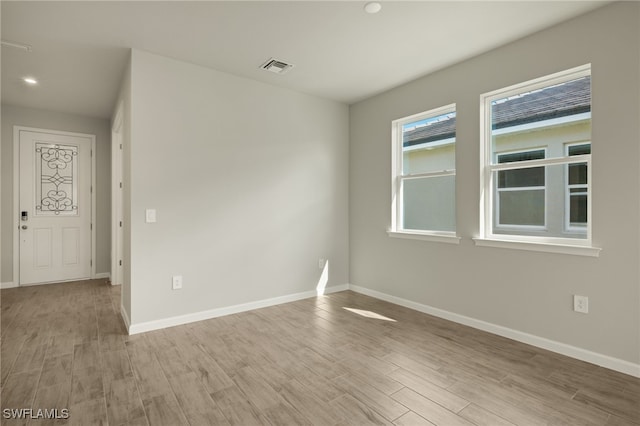 unfurnished room featuring light wood-type flooring