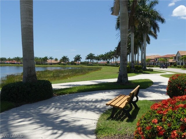 view of community with a water view and a lawn