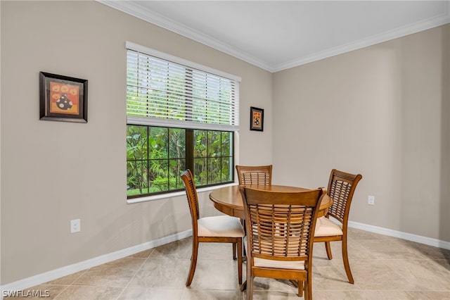 tiled dining room featuring crown molding