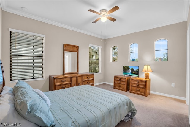 carpeted bedroom with ceiling fan, ornamental molding, and multiple windows