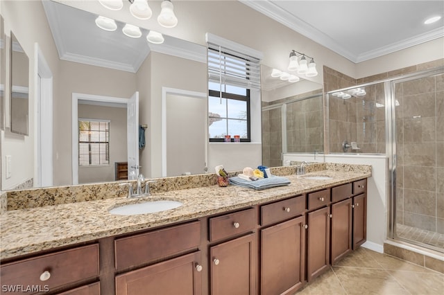 bathroom featuring tile patterned floors, crown molding, a shower with door, and vanity