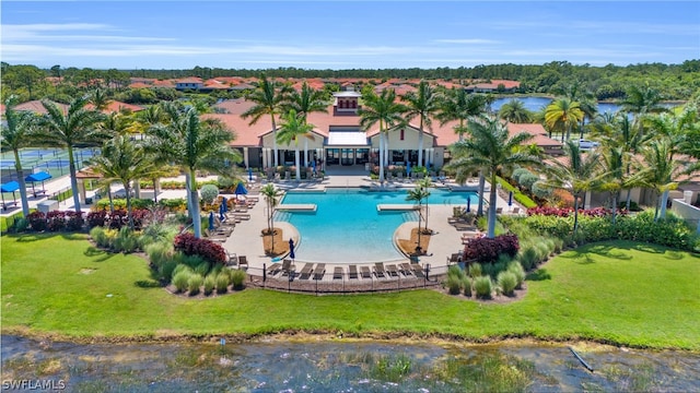 view of swimming pool with a patio area and a water view