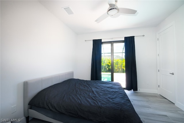 bedroom with light hardwood / wood-style floors, ceiling fan, access to exterior, and lofted ceiling