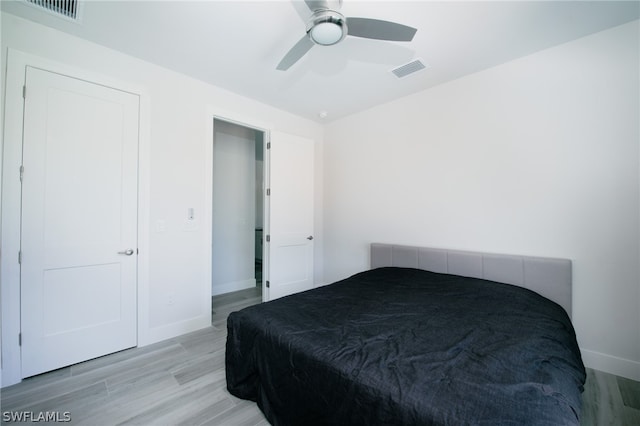 bedroom with ceiling fan and light wood-type flooring