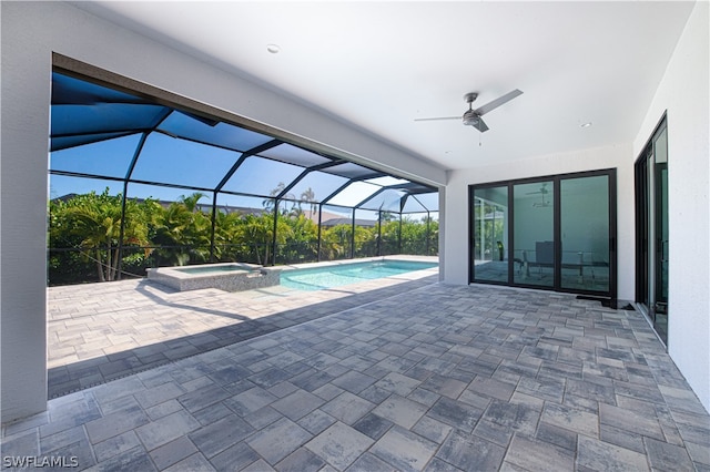 view of pool featuring a patio, a lanai, an in ground hot tub, and ceiling fan