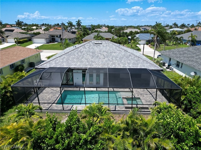 exterior space featuring glass enclosure and a patio area