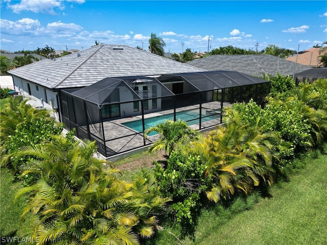 back of house featuring a lanai and a patio area