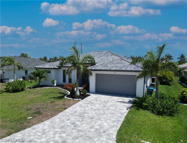 single story home with a garage and a front lawn