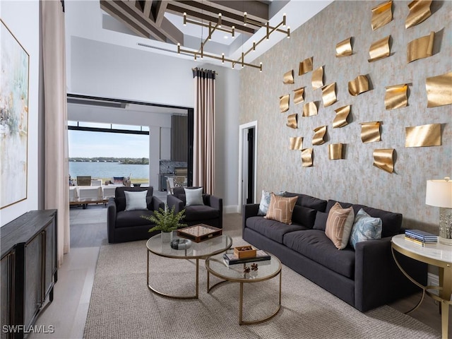 living room with a high ceiling and a water view