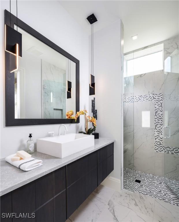 bathroom featuring walk in shower and vanity