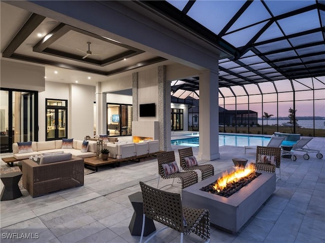 view of patio with an outdoor living space with a fire pit and glass enclosure