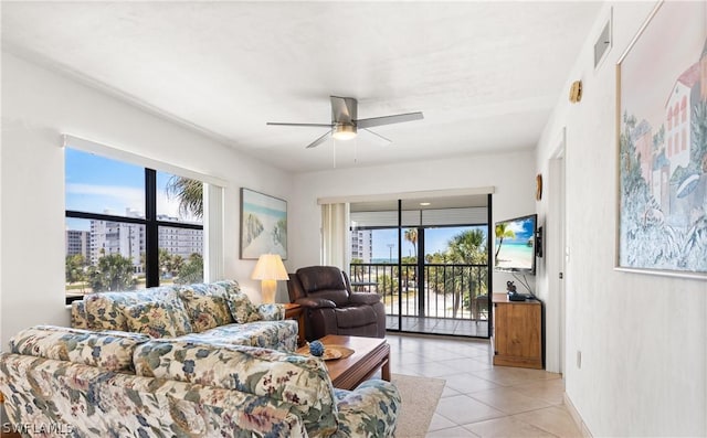 living room featuring plenty of natural light, ceiling fan, and light tile patterned floors