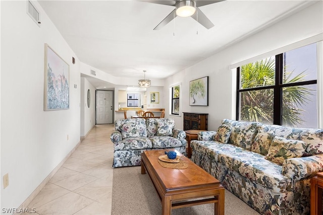 living room with ceiling fan, light tile patterned flooring, and a wealth of natural light