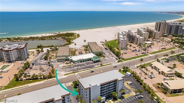 bird's eye view featuring a beach view and a water view