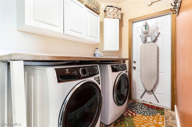 laundry area with cabinets and separate washer and dryer