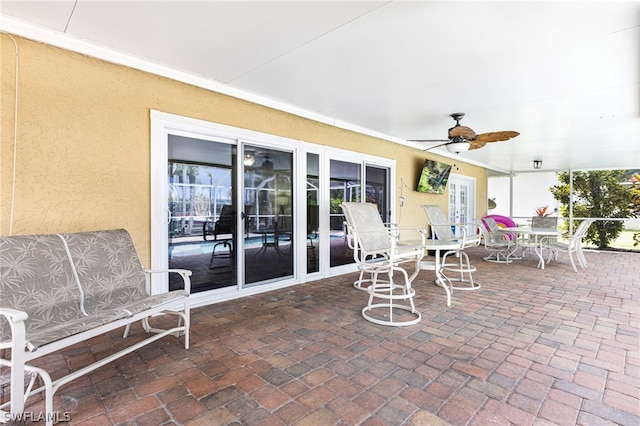 view of patio featuring french doors and ceiling fan