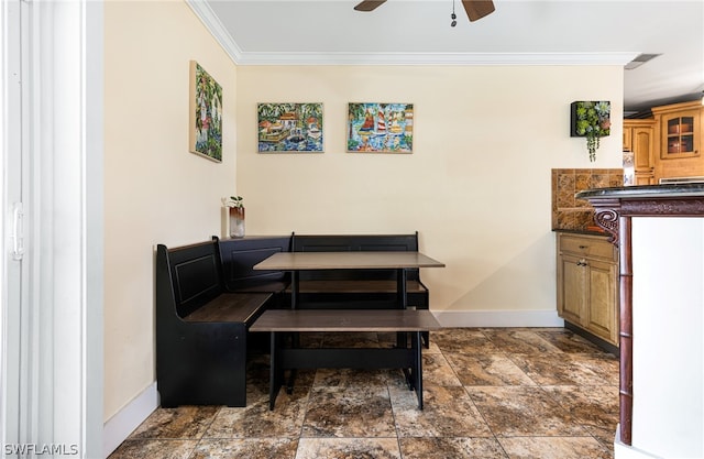 dining area featuring ceiling fan and ornamental molding