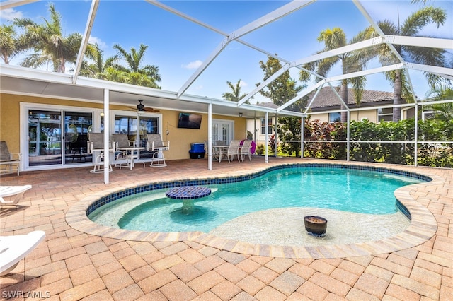 view of pool with a patio area, french doors, and glass enclosure