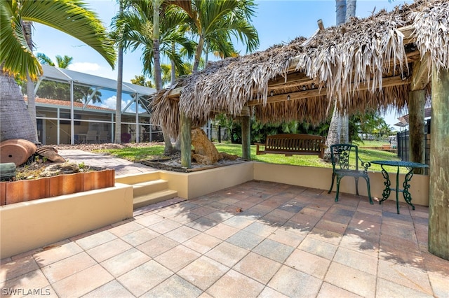 view of patio / terrace with a gazebo and glass enclosure