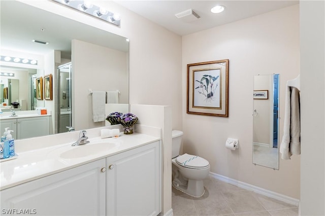 bathroom with walk in shower, tile patterned floors, vanity, and toilet