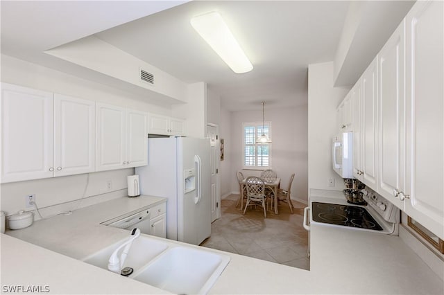 kitchen featuring white appliances, sink, decorative light fixtures, light tile patterned flooring, and white cabinetry