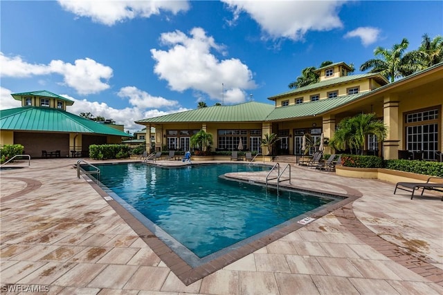 view of swimming pool with a patio