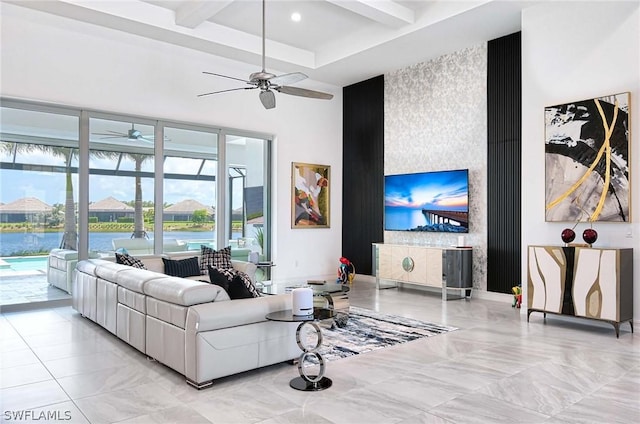 living room featuring beamed ceiling and a water view