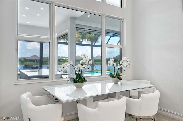 dining space with a healthy amount of sunlight and a water view